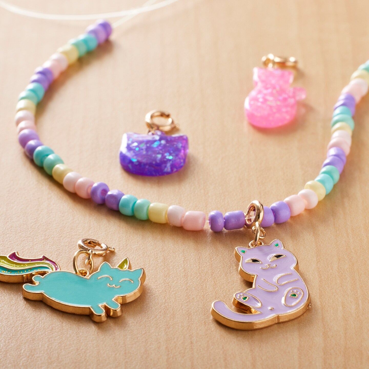 4 cat charms on a beaded necklace. 