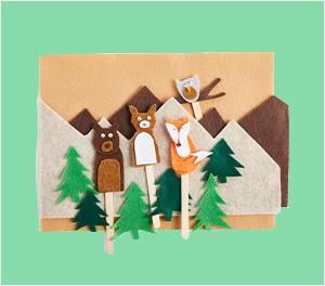 Felt woodland animals crafted over a forrest scene