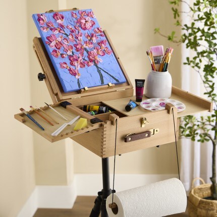 Easel sitting in room with a paining on it