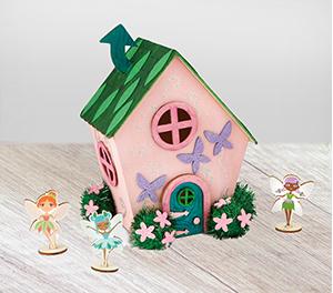 Wooden house with a green roof and pink walls with a small faerie