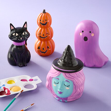 Ceramic kids crafts for halloween- black cat, stacked pumpkin, purple ghost, and pink witch. 