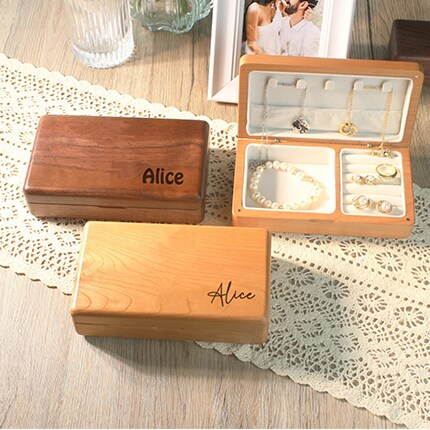 MakerPlace by Michaels MakerPlace by Michaels Engraved wooden jewelry boxes sit on a lace runner beside an open organizer holding pearl jewelry and rings, creating a warm, sentimental tone.
