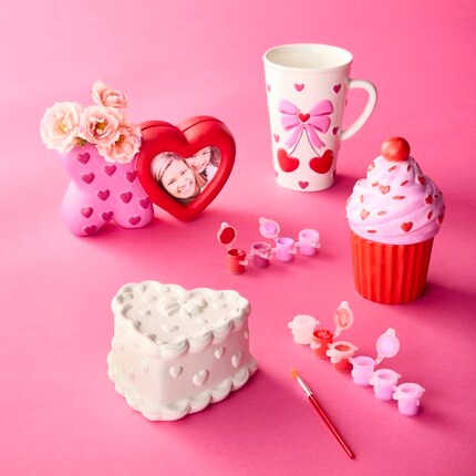 ceramic crafts unfinished and painted with pink backdrop. 