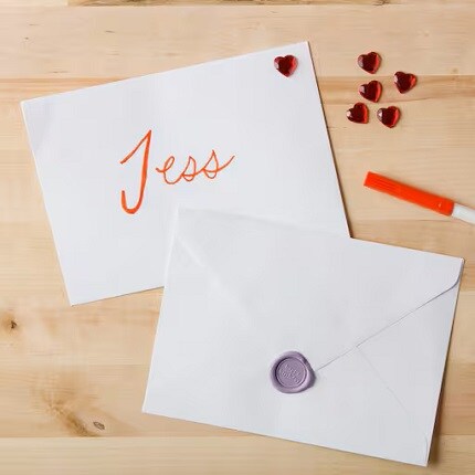two white envelops on wood table