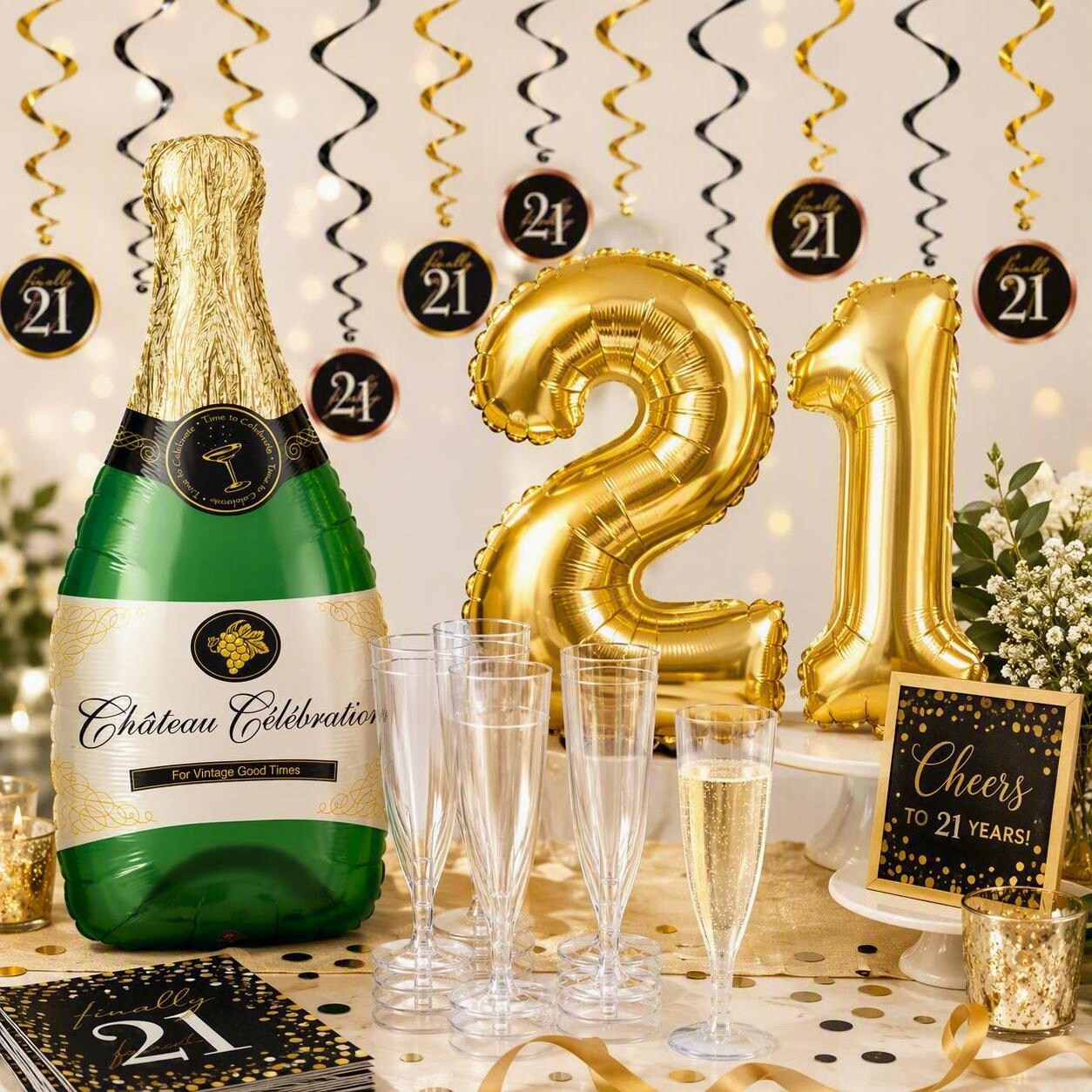 gold "21" balloons, a champagne bottle balloon, champagne glasses and 21st birthday decorations