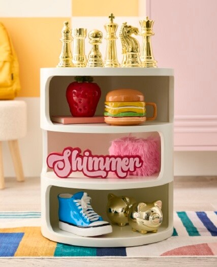 white shelves with gold chess pieces, blue shoe and ceramic hamburger mug accents