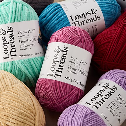 pink, light green and purple yarn in packaging with Loops & Threads logo