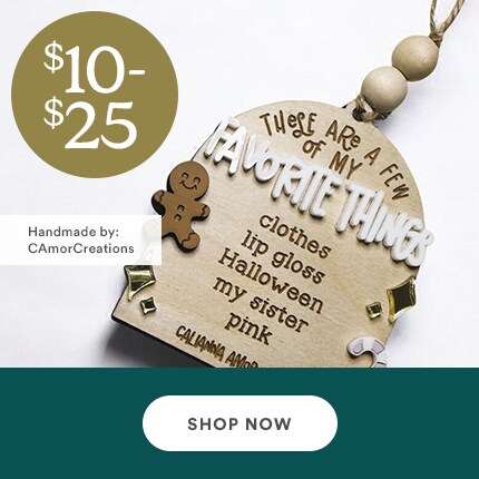 MakerPlace by Michaels Wooden ornament with engraved text on favorite things, featuring a gingerbread man and decorative elements. Price range $10-$25. Shop now button below.