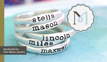 MakerPlace by Michaels Four stacked silver rings, each engraved with a name: Stella, Mason, Lincoln, Miles, Maxwell. Handmade by Chic Mama Jewelry. Soft, pastel background.