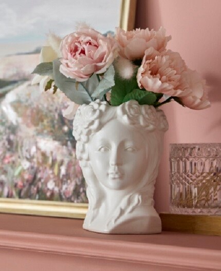 white female bust vase with pink flowers