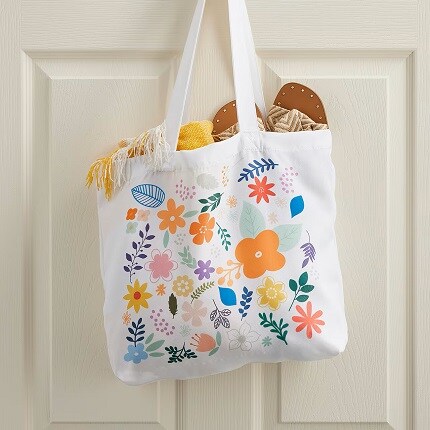 tote bag with floral design hanging on door