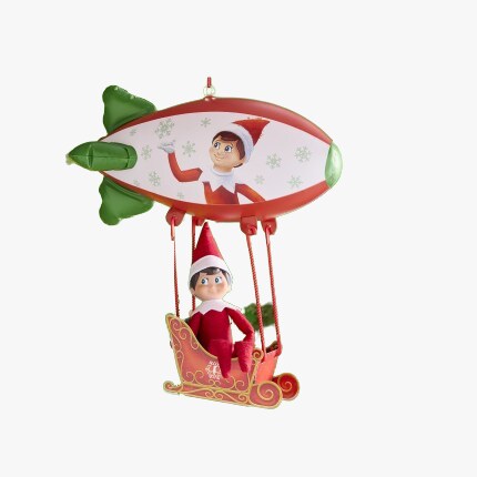 Scout the elf sitting in a blimp