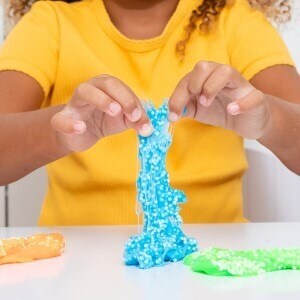 Child playing with blue slime