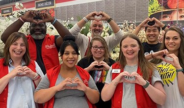 Michaels employees making hand signs of a heart