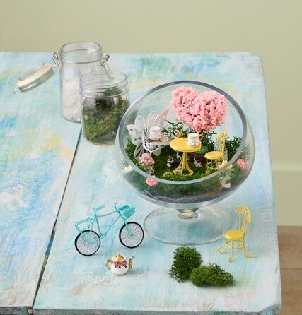 blue table with class terrarium an miniature scene supplies