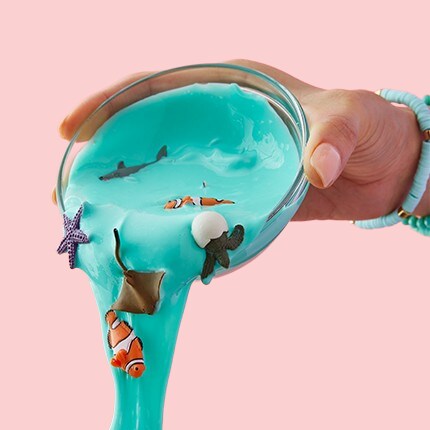 blue slime with aquatic animal figurines being poured out of a bowl