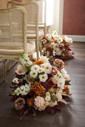 floral bouquet aisle decorations in white and orange tones