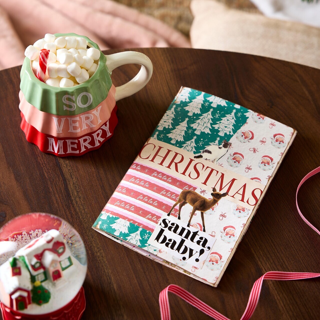 Collage holiday junk journal on a desk alongside holiday treats