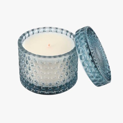 candle in blue glass container