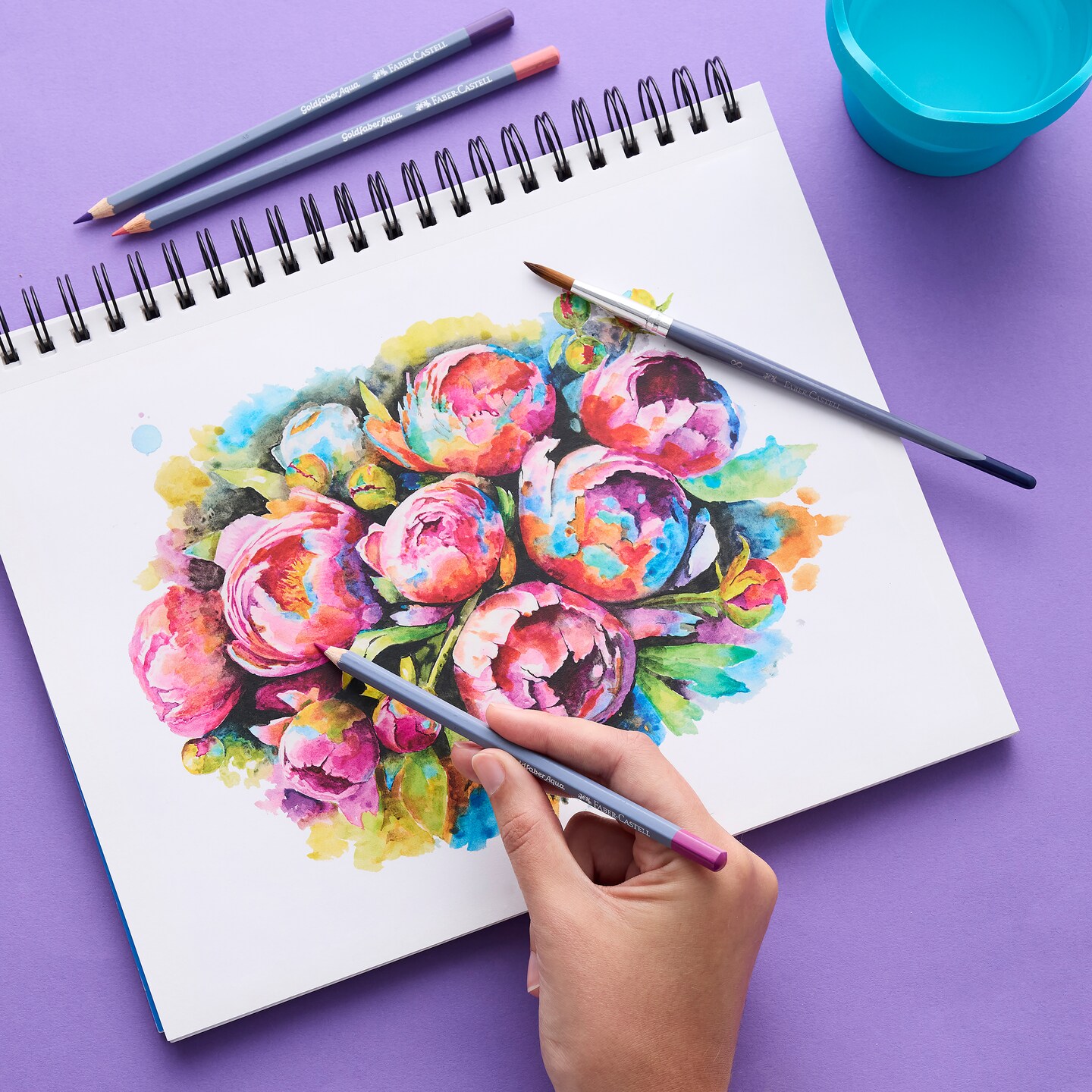 Someone drawing flowers with Faber Castell pencils