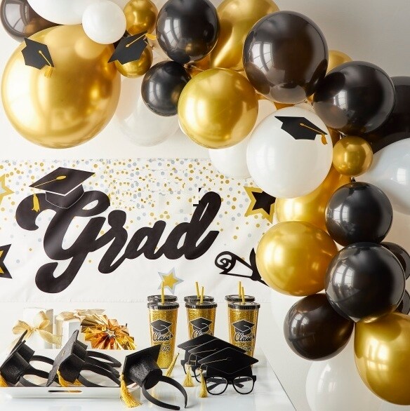 black and gold graduation party table, banner and balloon arch