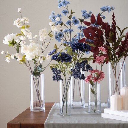 A group of flowers in glass vases