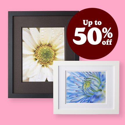 black matted frame and white matted frame with flower pictures on pink background with up to 50% off in white text over maroon bubble