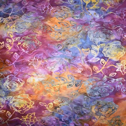 batik fabric with floral design and orange, purple and blue dyes