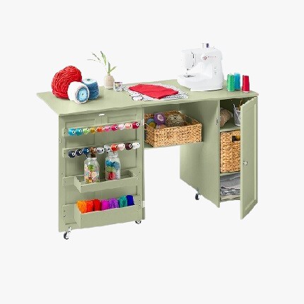 sewing table with yarn and sewing supplies