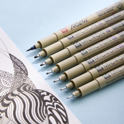 Pigma pens on blue background