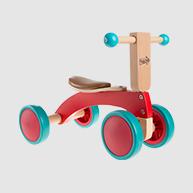 Wooden tricycle painted red and with blue wheels.