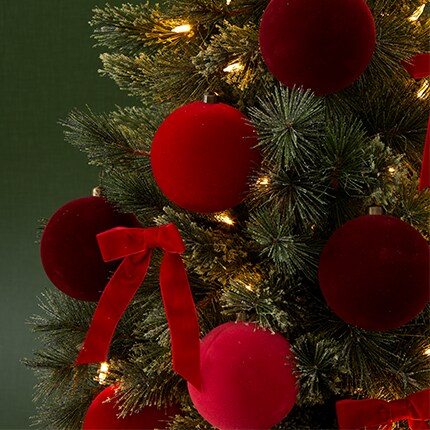 Christmas Tree Ornaments: red flocked ball ornaments hanging from a tree