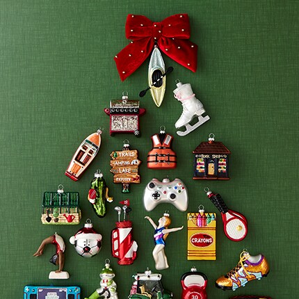 Collectible ornaments laid in a tree design with a red bow