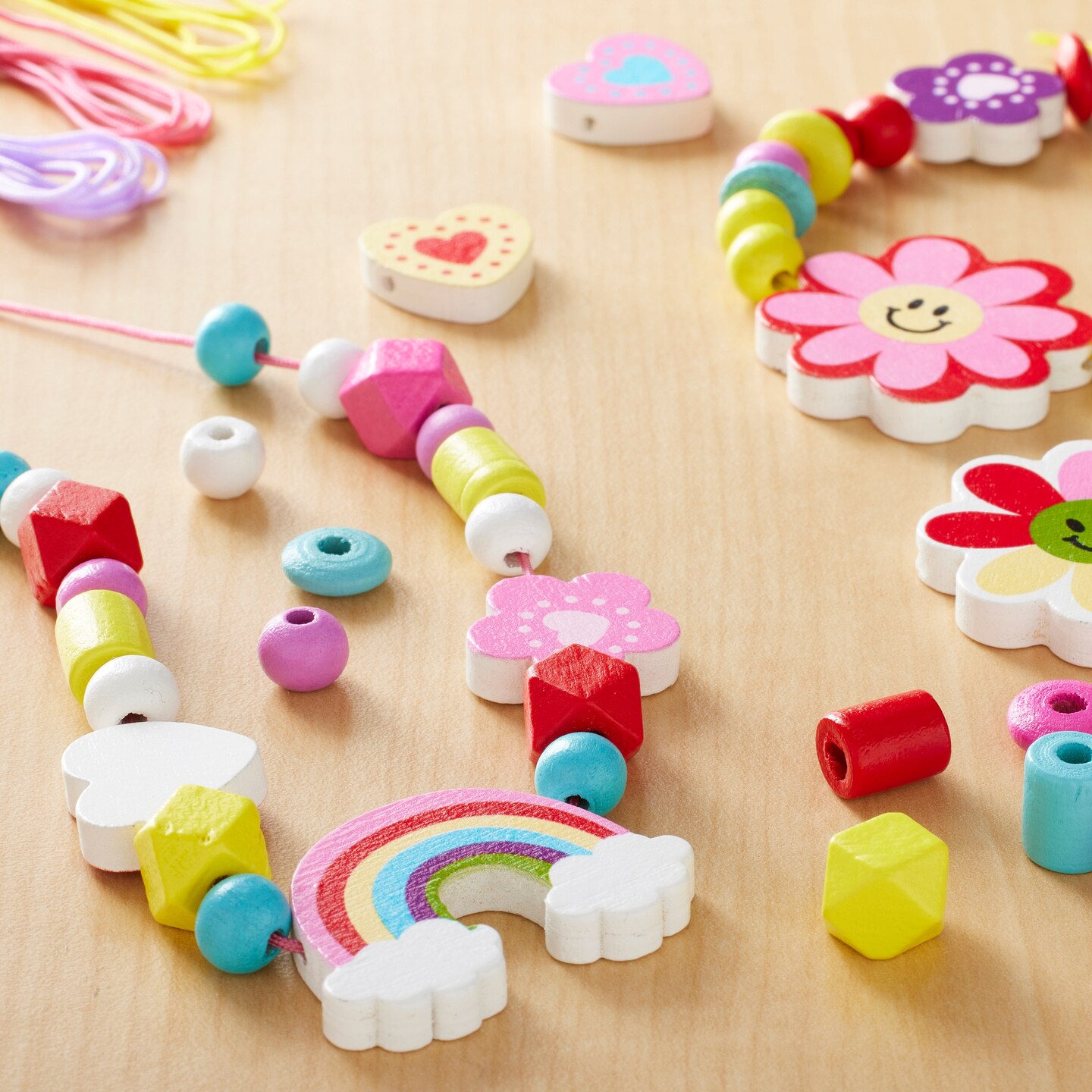 Kids Jewelry kit with flowers, rainbows, and other charms. 