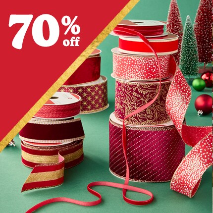 stacked spools of red decorative ribbon with 75 % off in white text over red triangle