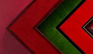 Red and green frames stacked next to each other with the Michaels custom framing branding.