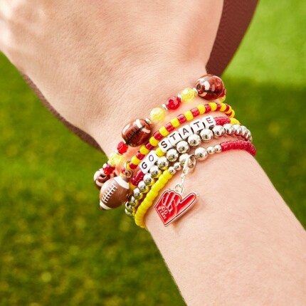 hand with stacked bead bracelets