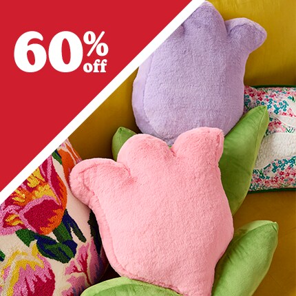 lips, smiley face and banana pillows on pink fuzzy chair