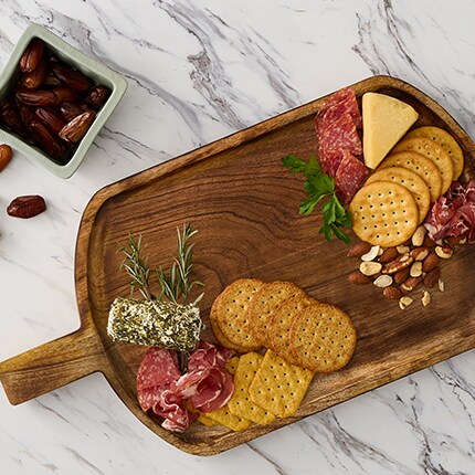 Cutting board on table with cheese cutting tray
