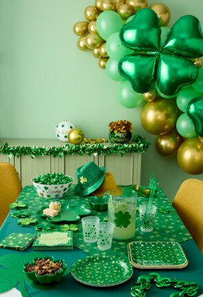 st. patrick's day party table with balloons