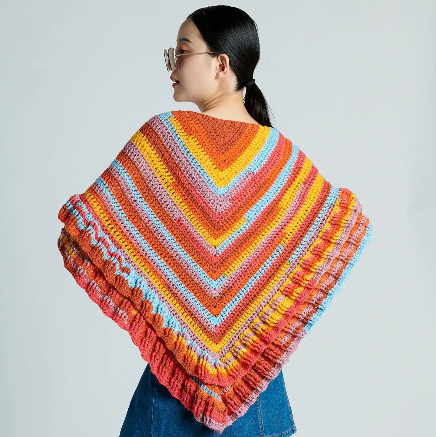 A woman wearing a crochet poncho