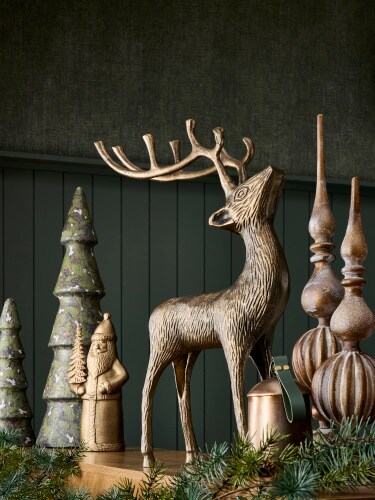 gold reindeer on wood mantel with gold holiday accents