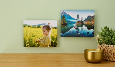 Metal printed frames hung next to each other on a wall.