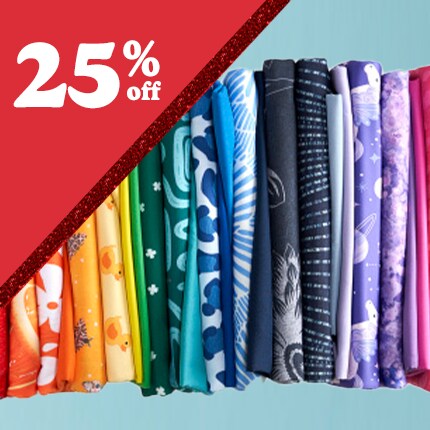 colorful printed fabrics stacked in rainbow order with 25% off in white text in red triangle