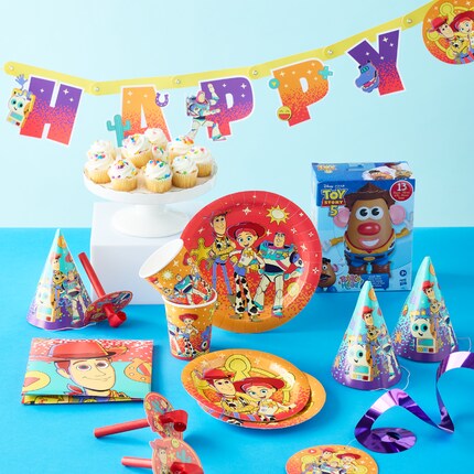 Toy story party setup with movie decor, including plates, napkins, cups, and more.