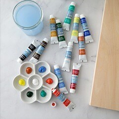 tubes of paint sprawled out on a counter with a paint tray