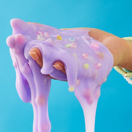 hand holding purple slime