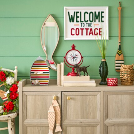 Cottage fishing cabin decor with welcome to the cottage sign and wooden accents
