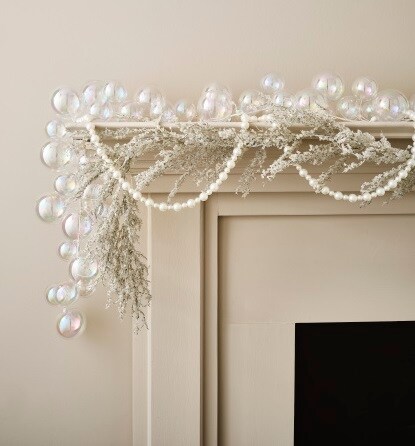 pearl and silver garlands on tan mantel