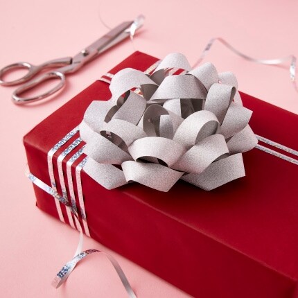 red box with silver ribbon and bow with scissors